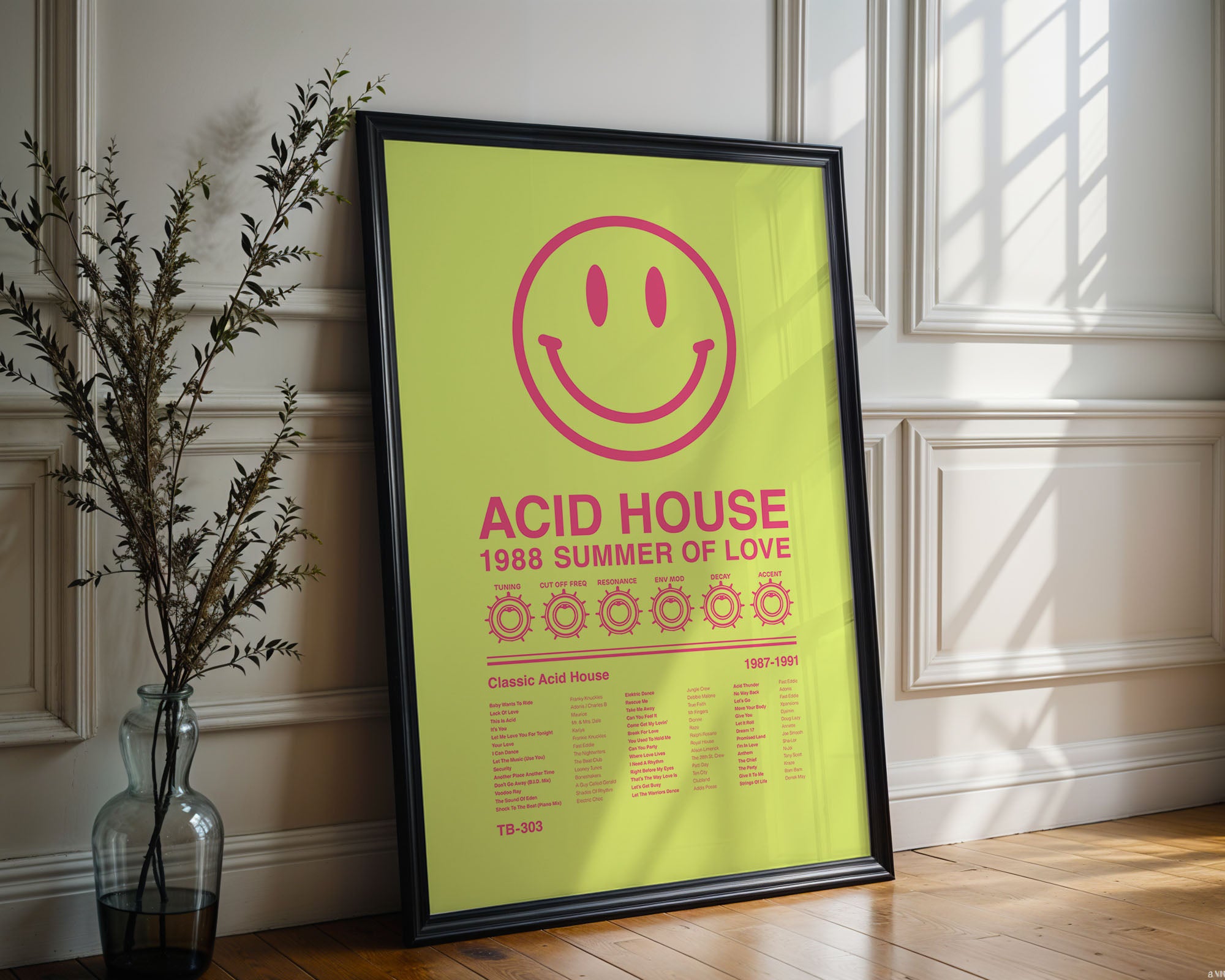 Acid House Smiley Face music print in a black frame leaning against an ornate white wall with natural window reflections and soft wall shadows. Suitable for A1, A2 and A3 sizes. Acid yellow background with electric pink text (Mockup M07).