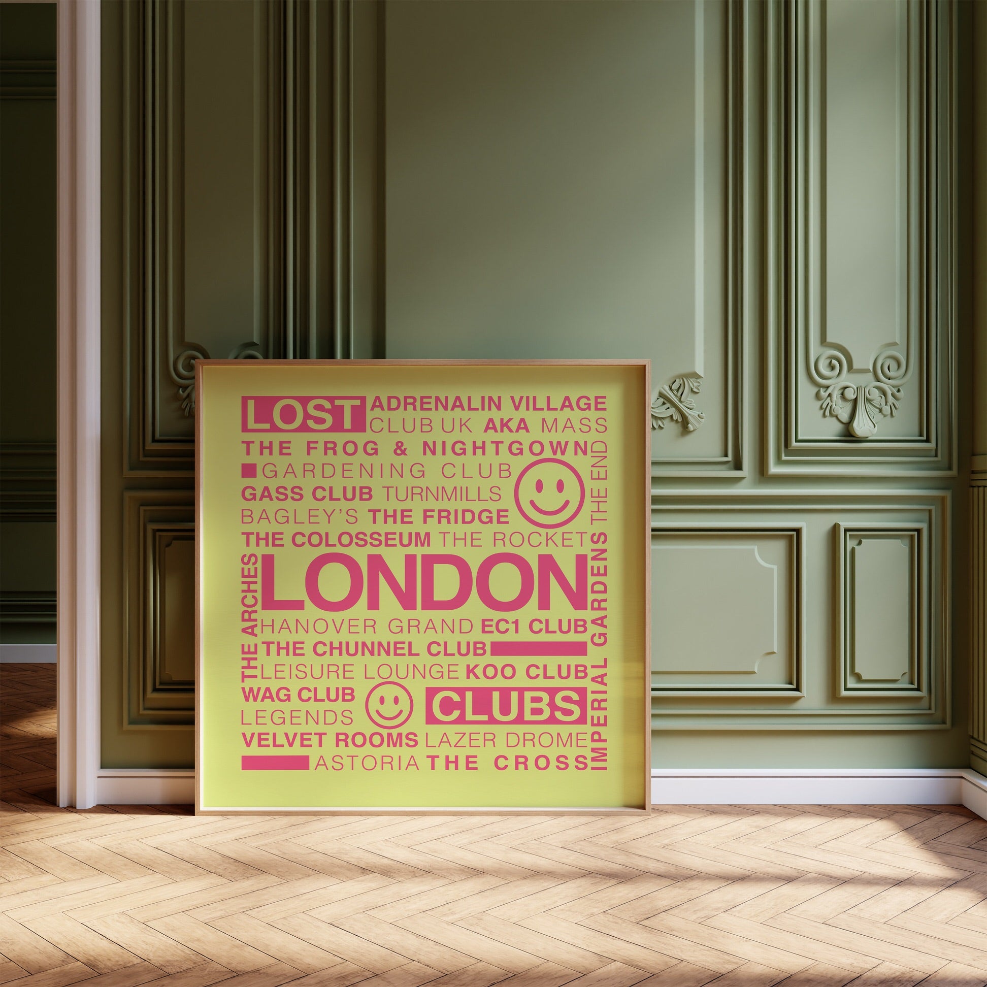 Lost London Clubs square acid yellow print with electric pink text in a wooden frame leaning on a wood floor against an olive ornate wall